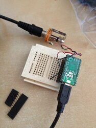 A Teensy microcontroller on a breadboard being wired to a 1/4" audio jack