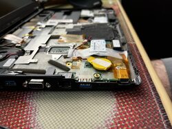 A close up of the side of the laptop where the missing port cover over the old Expresscard slot is