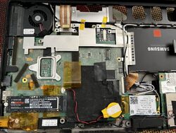 The laptop opened up to the motherboard, with the SSD replaced