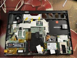 The laptop with the display fully removed and motherboard exposed