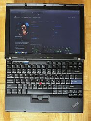 X210 doing the classic Thinkpad thing where the screen is opened 180 to be flat with the keyboard