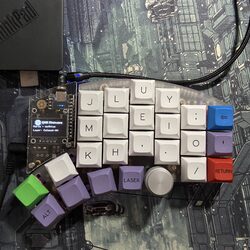 Half of my split keyboard, today, with the white, green, purple, and red key cap set