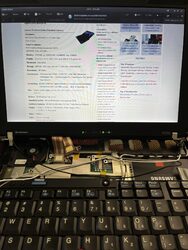 Testing the new display by plugging it into the motherboard, with keyboard removed